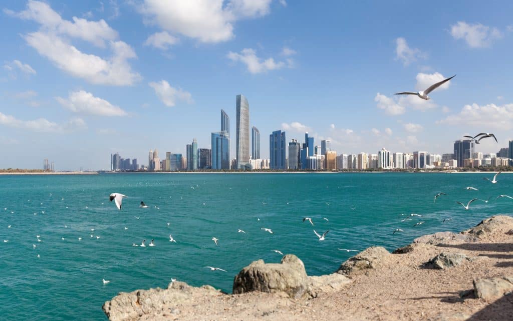 Lohnt sich Dubai? Warum Dubai? Abu Dhabi cityscape during sunny day with seagulls flying around